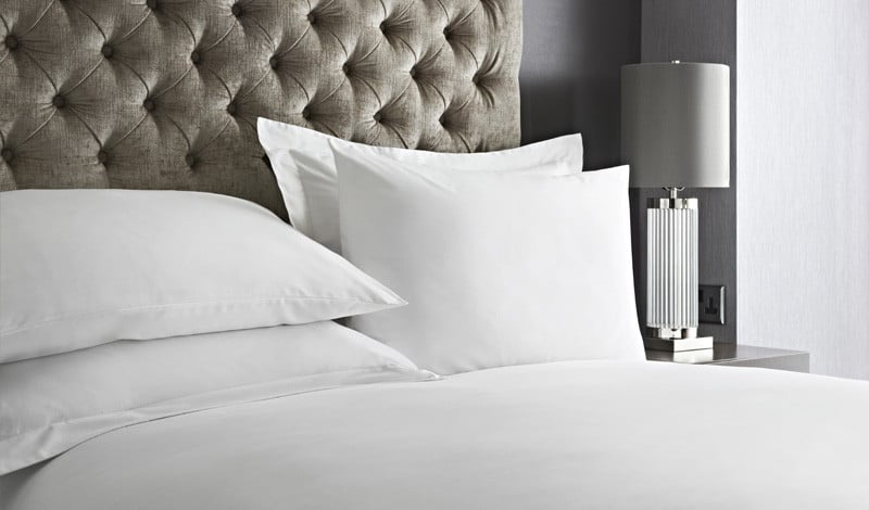 Crisp white hotel bed linen