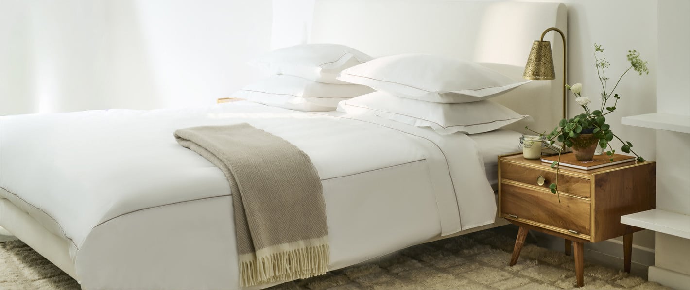 Crisp white hotel bed linen