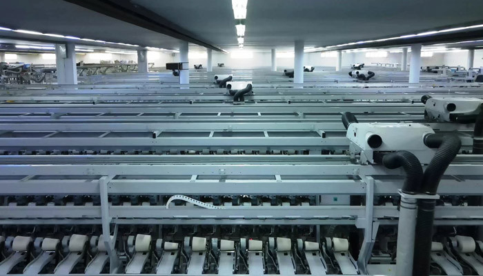 Rows of modern automated spinning frames in a bright partner mill